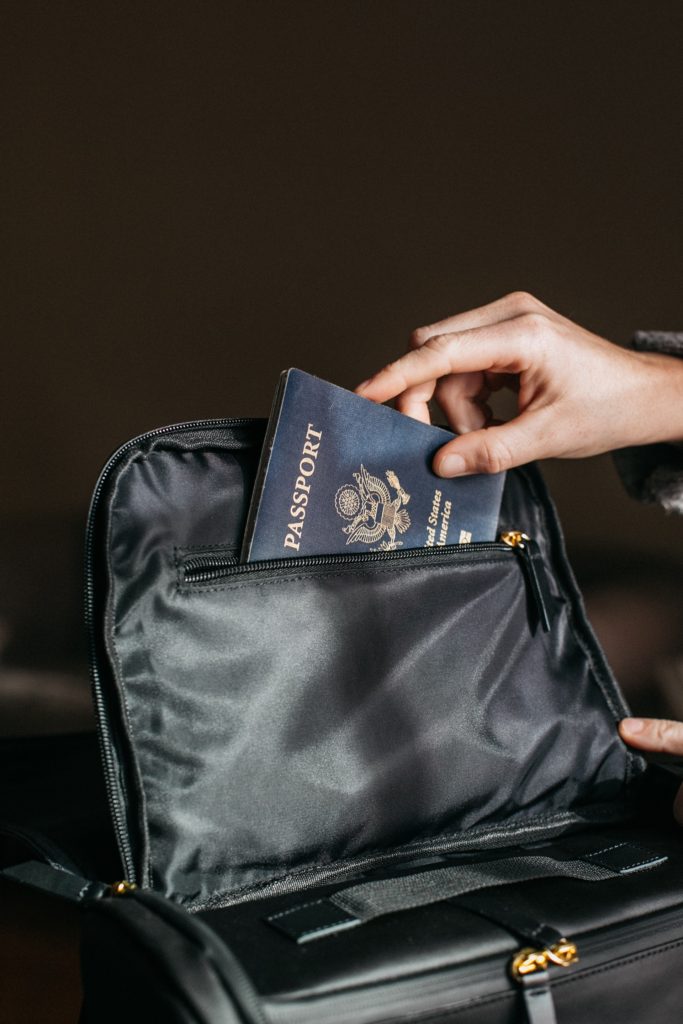 putting a passport into a bag, referring to immigration